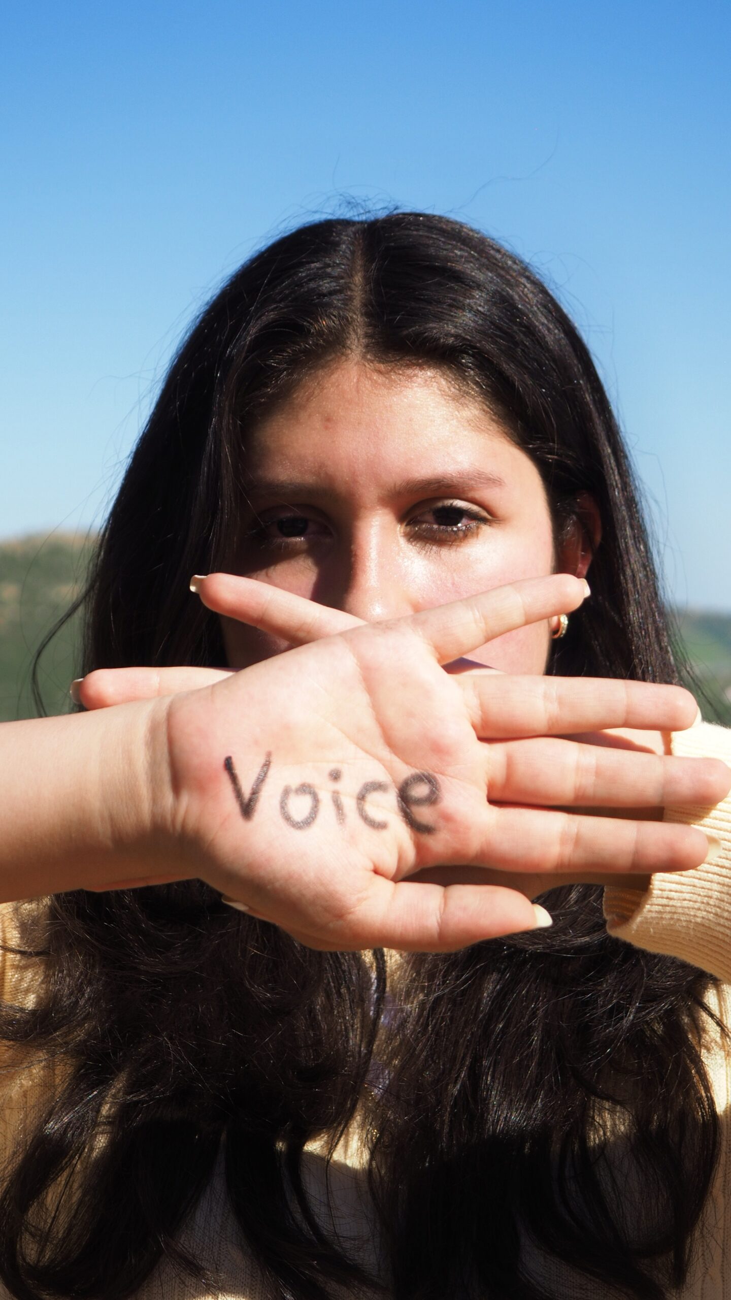 woman with the word voice written in her hand