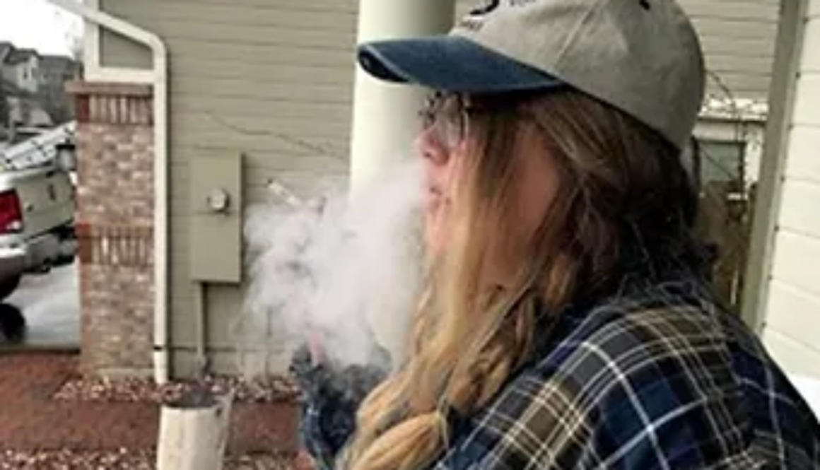 woman with cap smoking cigar
